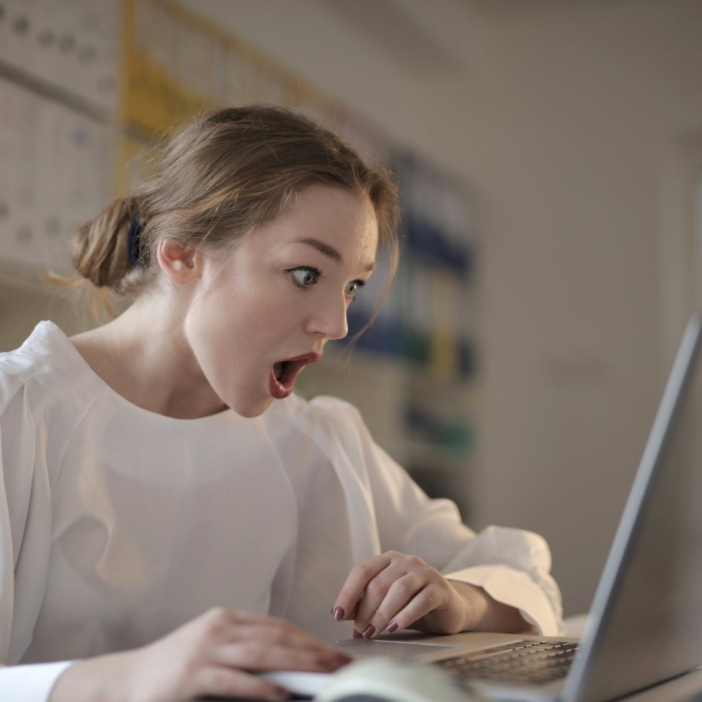 Woman in White Long Sleeve Shirt Using Silver Laptop Computer